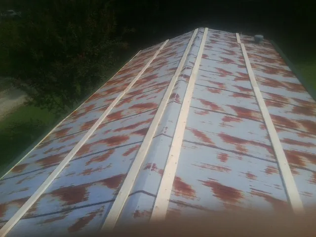 Rusted metal roof panels with new wood purlins before replacement — Storm Damage Roof Repair in Walhonding by Roofing Brothers